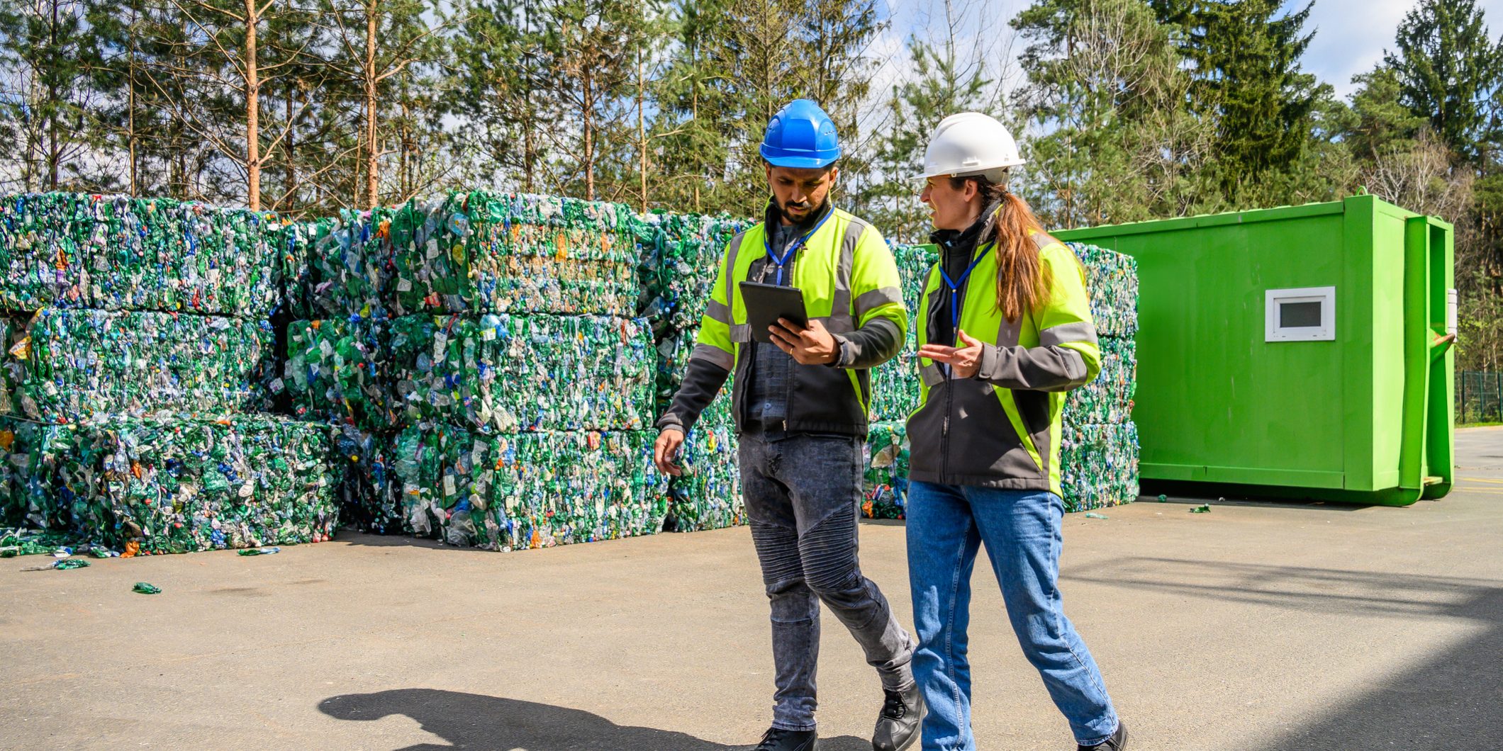 Inspecting Recycled Materials at a Recycling Facility Environmental consultants reviewing a UK permit application with technical documents