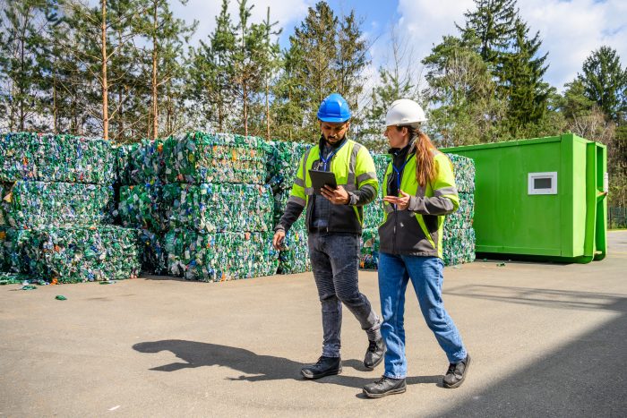 Inspecting Recycled Materials at a Recycling Facility Environmental consultants reviewing a UK permit application with technical documents