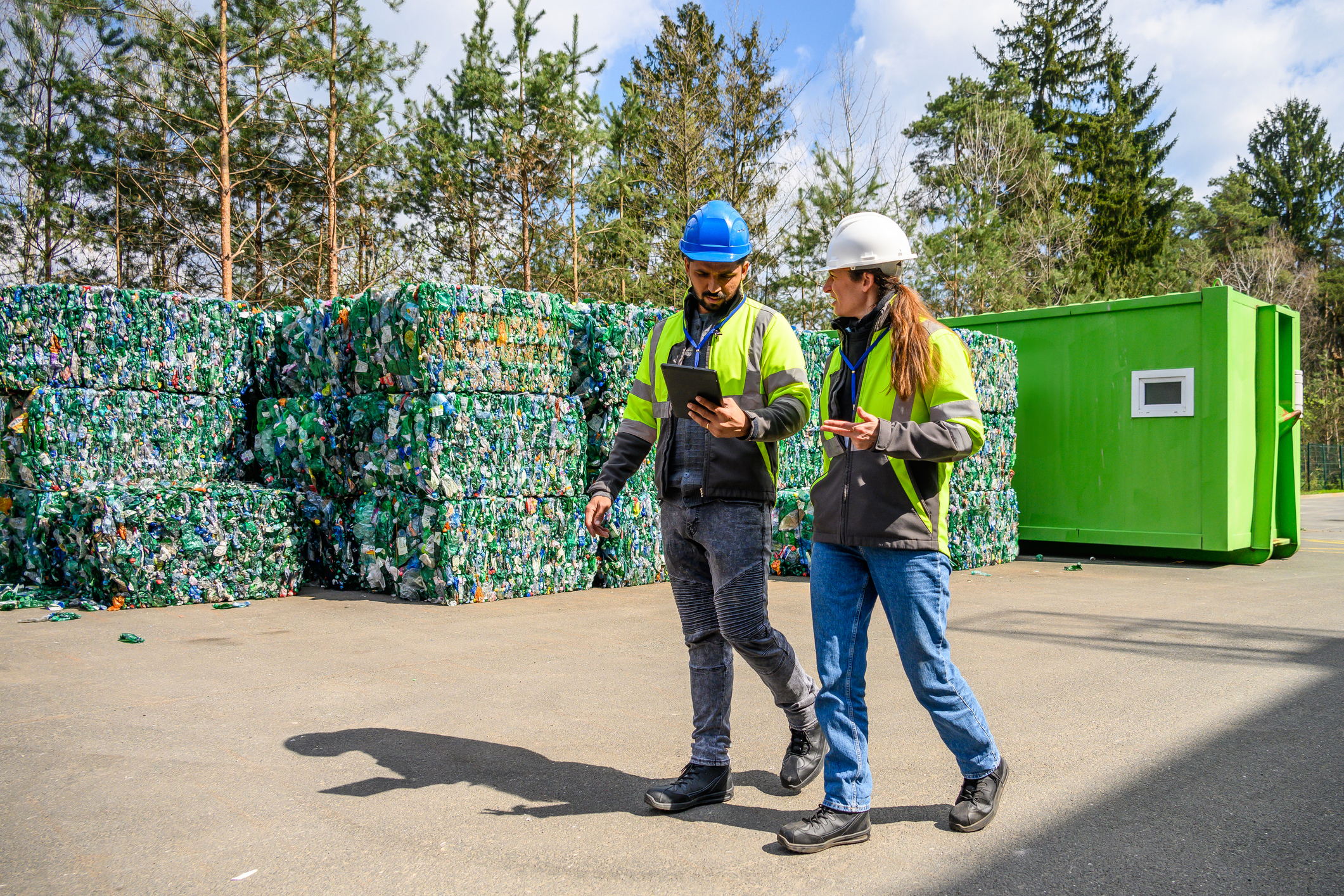 Inspecting Recycled Materials at a Recycling Facility Environmental consultants reviewing a UK permit application with technical documents